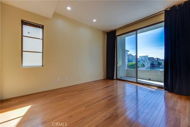 empty room with hardwood / wood-style flooring