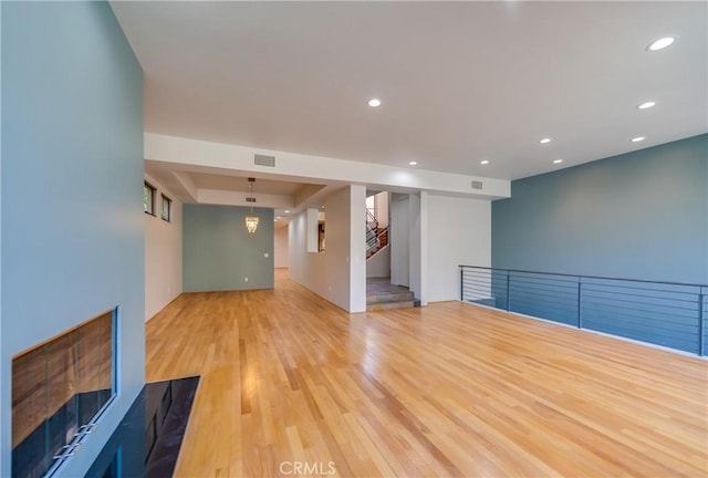 unfurnished living room featuring light wood-type flooring