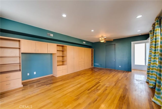 unfurnished living room featuring ceiling fan and light wood-type flooring