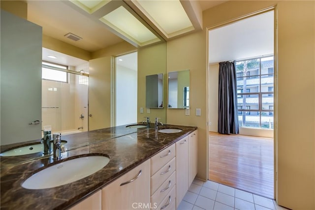 bathroom featuring tile patterned flooring and vanity