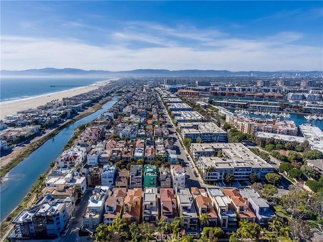 birds eye view of property with a view of the beach and a water and mountain view