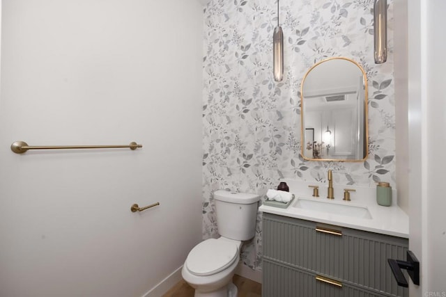 bathroom featuring vanity and toilet