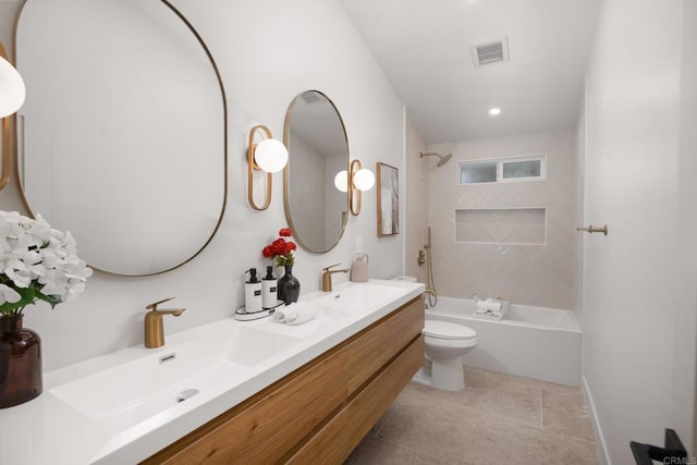 full bathroom with tiled shower / bath, vanity, toilet, and tile patterned flooring