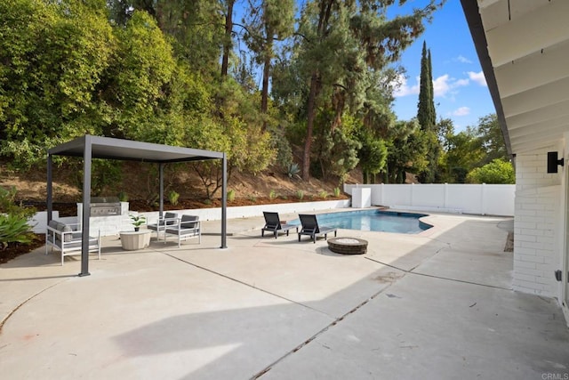 view of pool with a fire pit, grilling area, and a patio