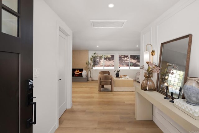 corridor featuring light hardwood / wood-style flooring and a wealth of natural light