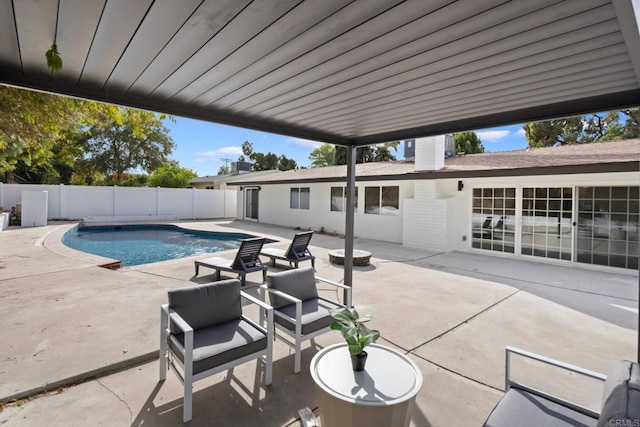 view of pool with a patio and a fire pit