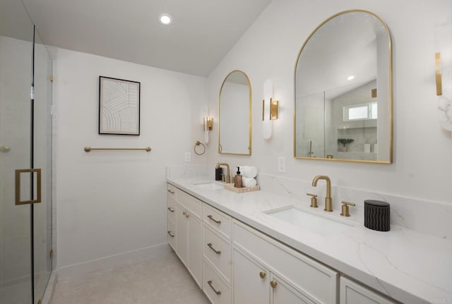 bathroom with lofted ceiling, a shower with door, and vanity