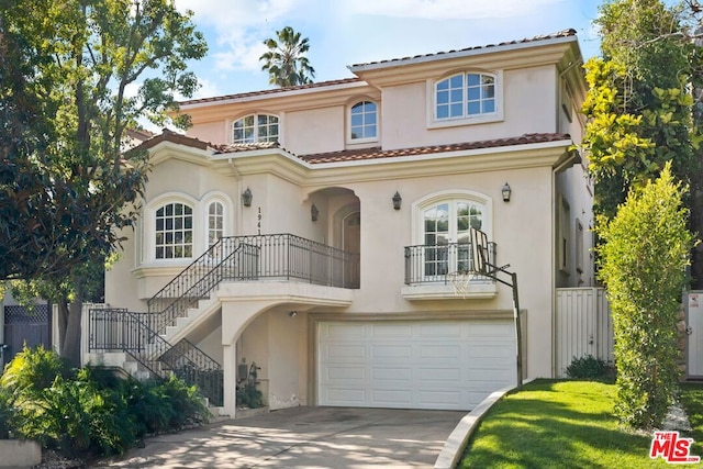 mediterranean / spanish-style home featuring a balcony and a garage