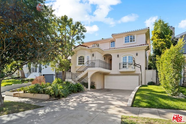 mediterranean / spanish house featuring a garage