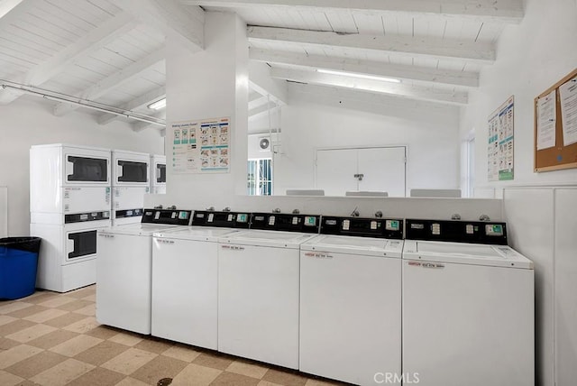 kitchen with lofted ceiling with beams, white cabinetry, and washing machine and clothes dryer