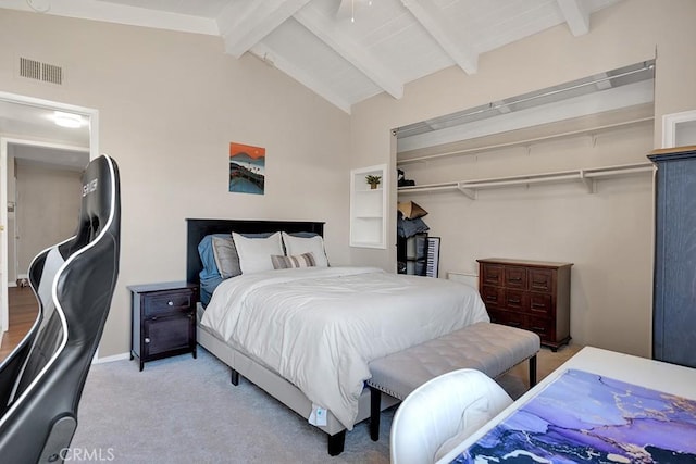 carpeted bedroom with vaulted ceiling with beams