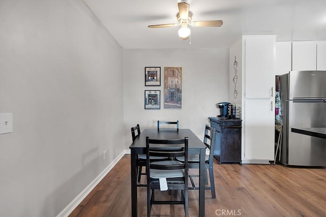 dining room with ceiling fan and light hardwood / wood-style floors