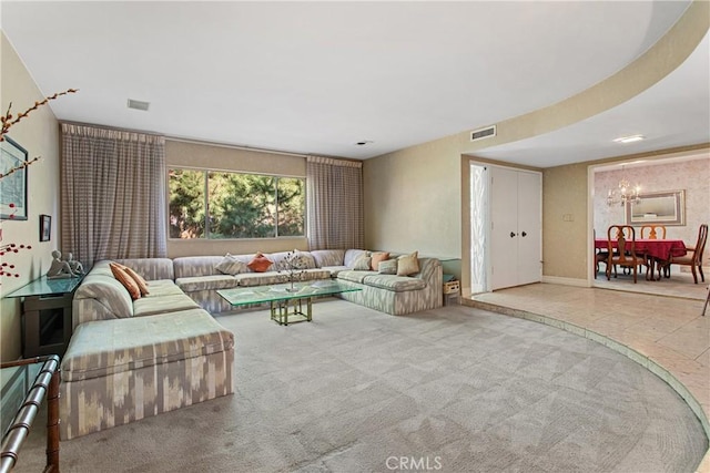 living room with an inviting chandelier and carpet