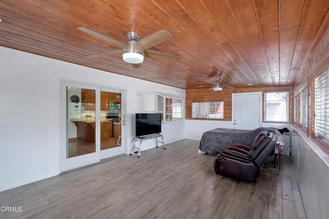 bedroom with wooden ceiling and wood finished floors