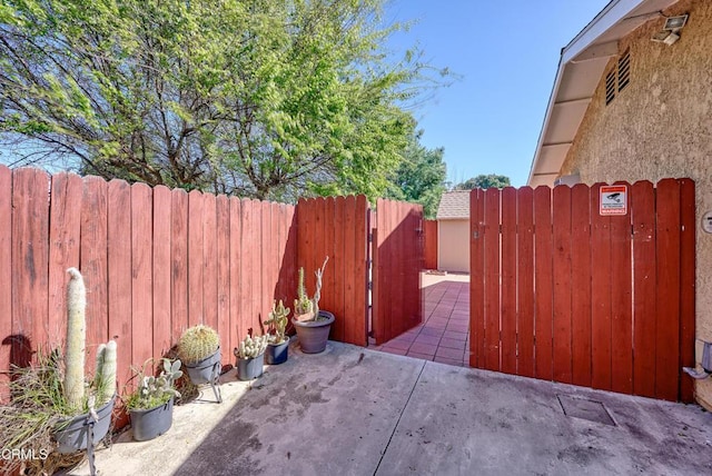 view of patio with a gate and fence