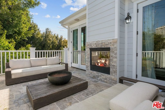 view of patio / terrace featuring an outdoor living space with a fireplace