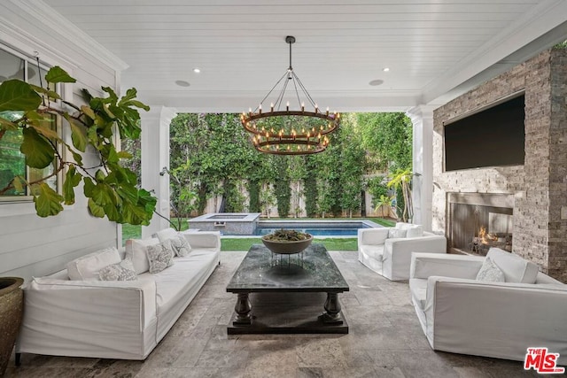 view of patio with an outdoor living space with a fireplace