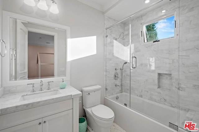 full bathroom featuring bath / shower combo with glass door, ornamental molding, vanity, and toilet