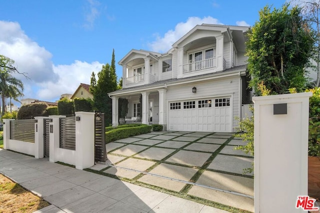 view of front of home featuring a balcony and a garage