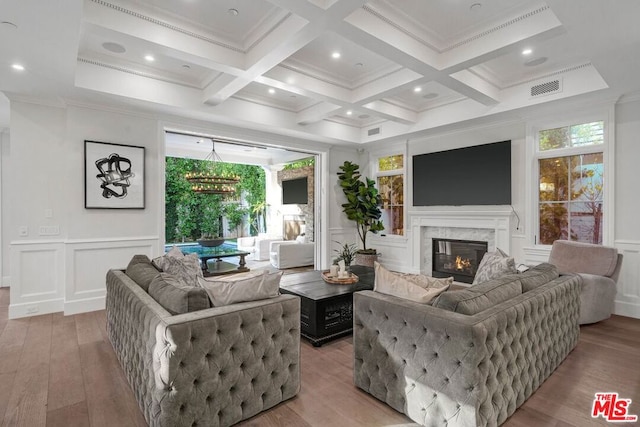 living room with coffered ceiling, beam ceiling, and a fireplace