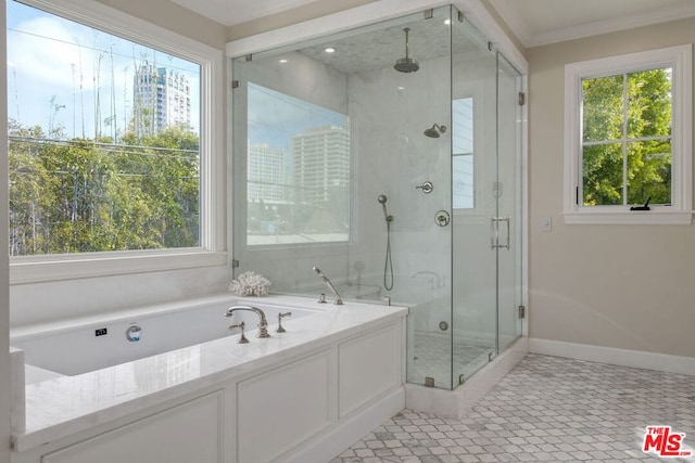 bathroom featuring ornamental molding, shower with separate bathtub, and a healthy amount of sunlight