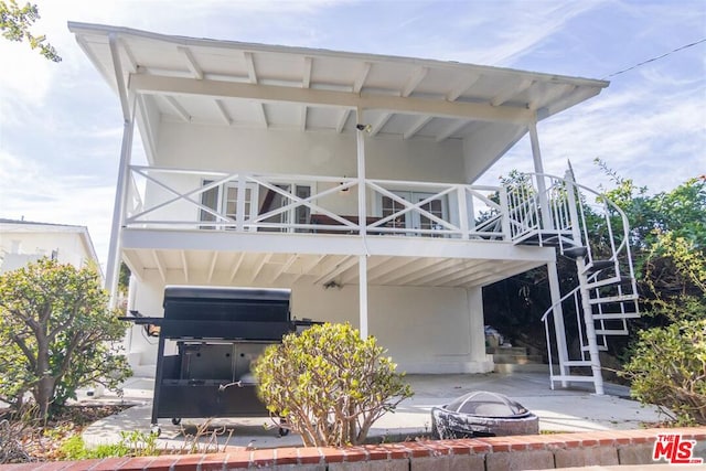 exterior space featuring a patio area and an outdoor fire pit