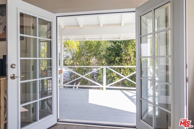 doorway with beam ceiling and french doors