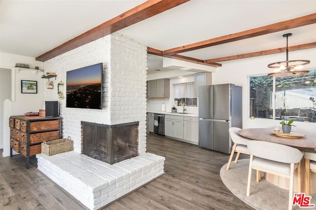 living room with beamed ceiling, dark hardwood / wood-style floors, a fireplace, and sink