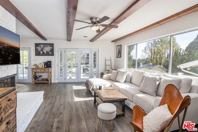 living room with french doors, dark hardwood / wood-style floors, beam ceiling, and a brick fireplace