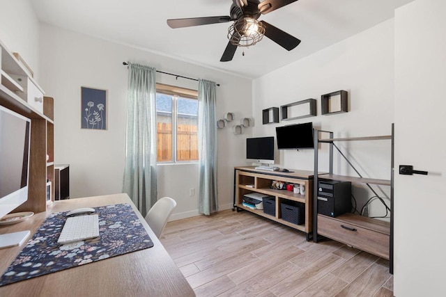 office area with light hardwood / wood-style flooring and ceiling fan