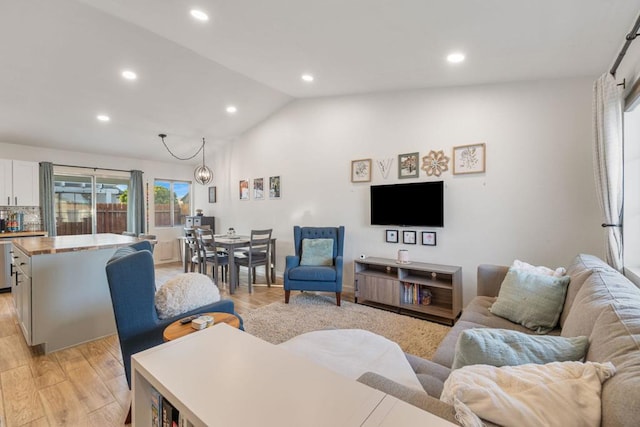 living room with lofted ceiling and light hardwood / wood-style floors