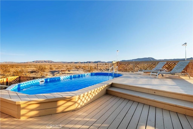 view of pool with a deck with mountain view