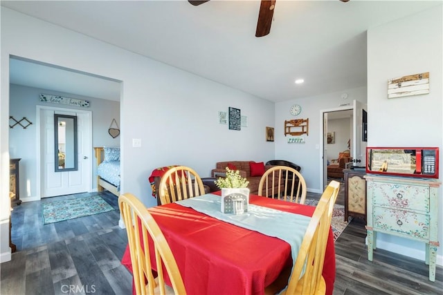 dining space with ceiling fan and dark hardwood / wood-style flooring