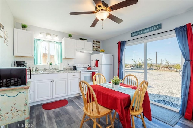 kitchen featuring white cabinetry, sink, and white appliances