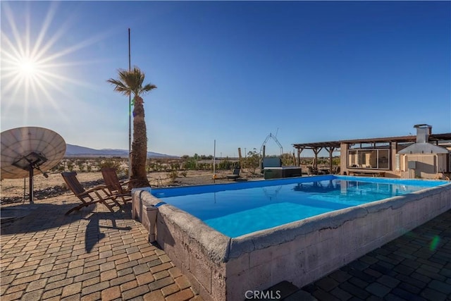 view of pool featuring a pergola, a mountain view, and a patio