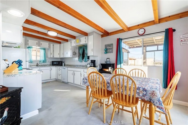 kitchen featuring white cabinetry, white fridge, backsplash, and beam ceiling