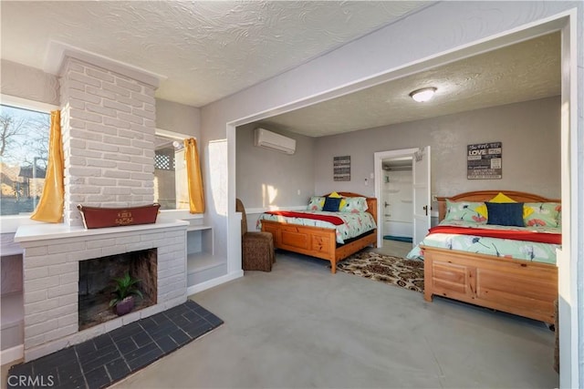 bedroom featuring a wall mounted air conditioner, a fireplace, concrete floors, and a textured ceiling