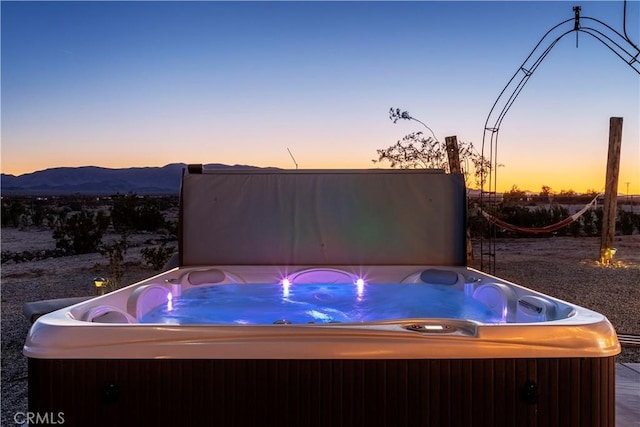 exterior space featuring a hot tub and a mountain view