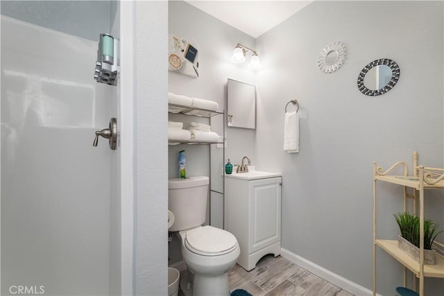 bathroom featuring hardwood / wood-style flooring, vanity, and toilet