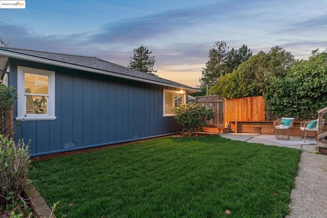 yard at dusk with a patio