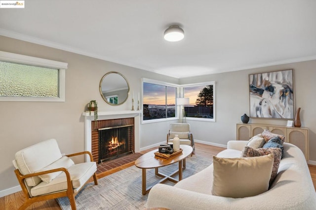 living room featuring hardwood / wood-style flooring, a healthy amount of sunlight, and a brick fireplace