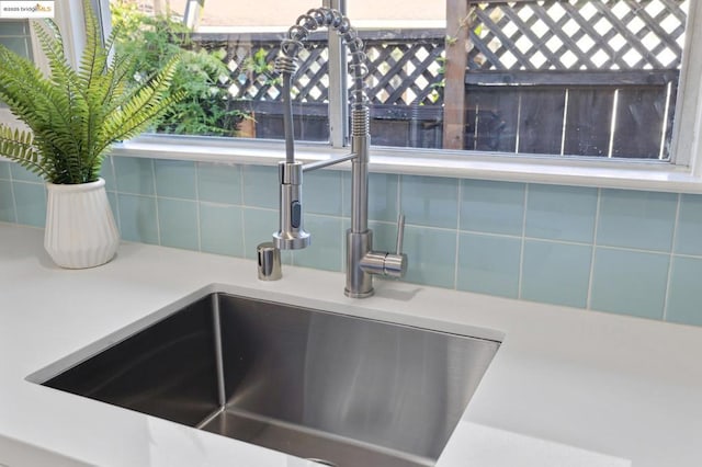 interior details with sink and decorative backsplash