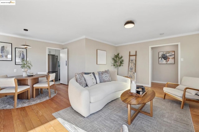 living room with light hardwood / wood-style flooring and ornamental molding