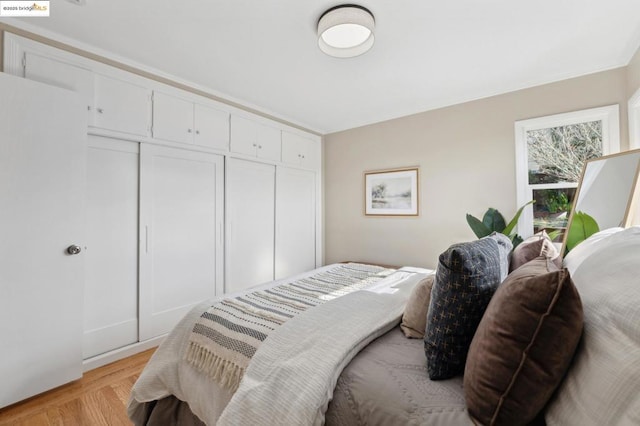 bedroom with a closet and light parquet floors