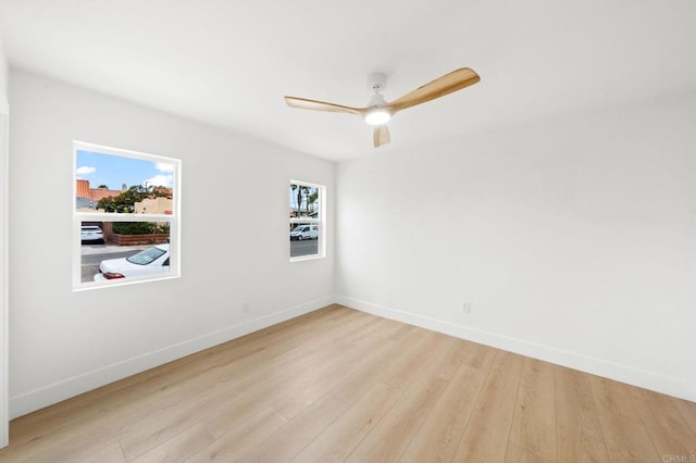 spare room featuring ceiling fan and light hardwood / wood-style flooring