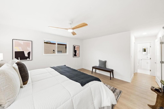 bedroom with ceiling fan, ensuite bathroom, and light wood-type flooring