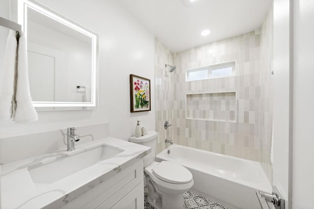 full bathroom with tiled shower / bath, vanity, and toilet