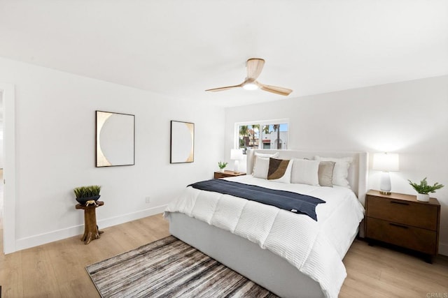 bedroom with ceiling fan and light hardwood / wood-style floors