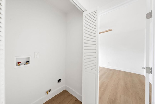 washroom with hookup for a gas dryer, washer hookup, and light wood-type flooring