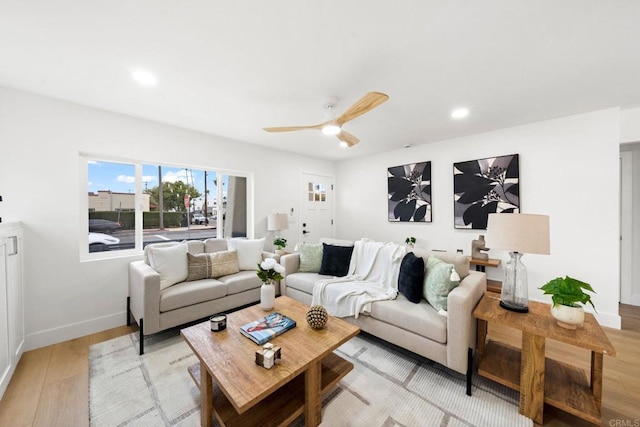 living room featuring ceiling fan and light hardwood / wood-style floors